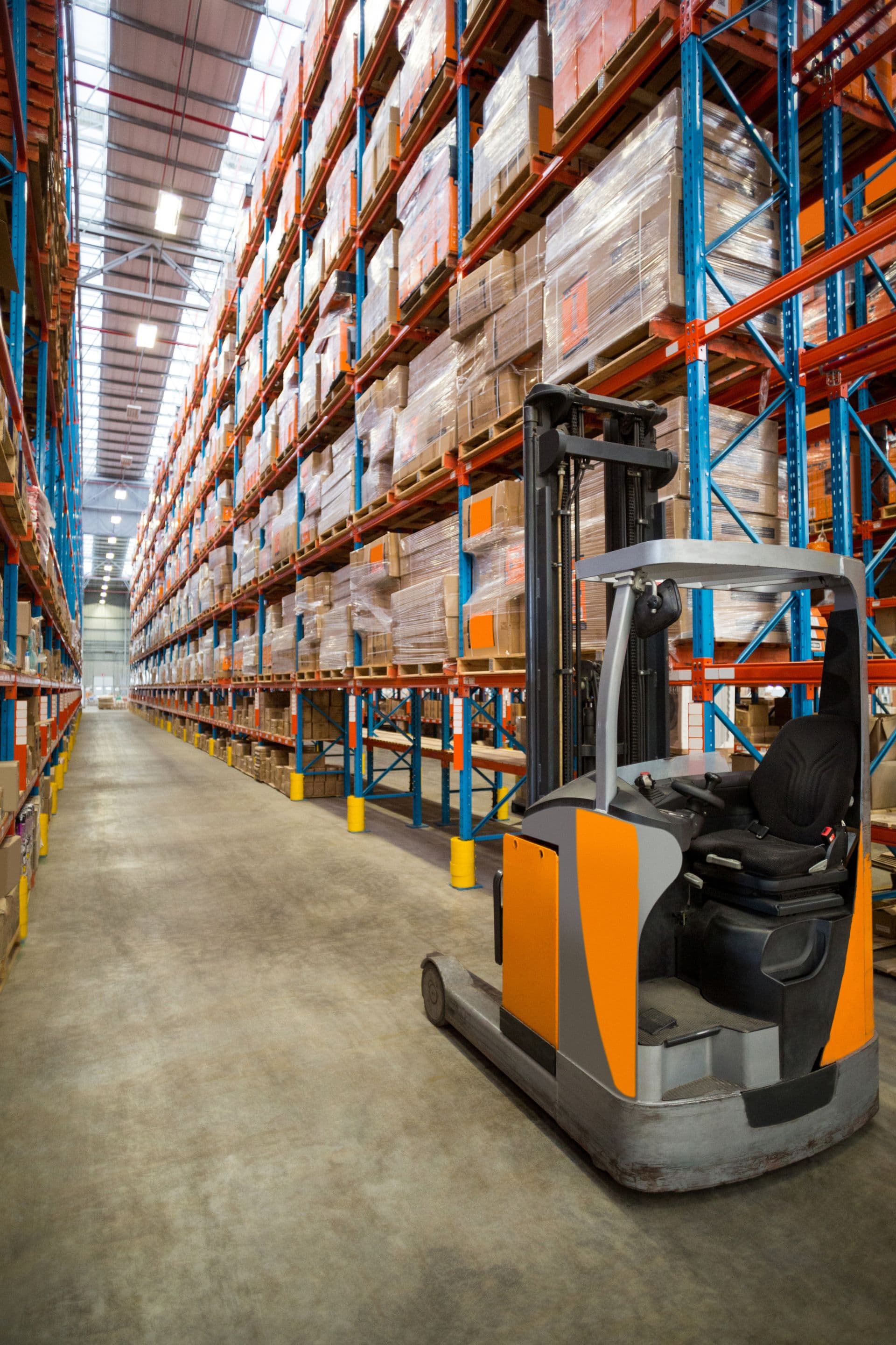 Forklift in a warehouse with shelves and pallets